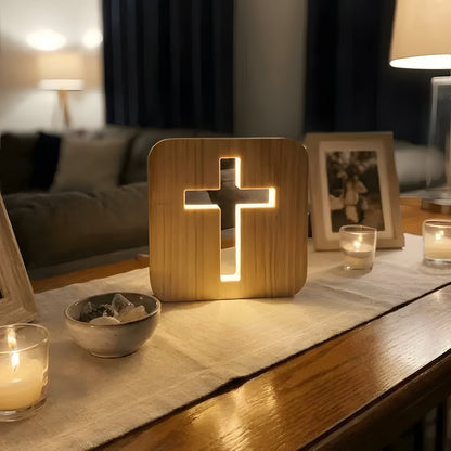 Wooden cross lamp on cozy tabletop with candles and photo frame